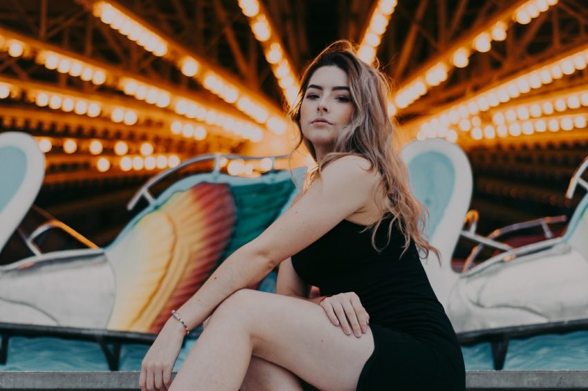 woman sitting in front of amusement ride